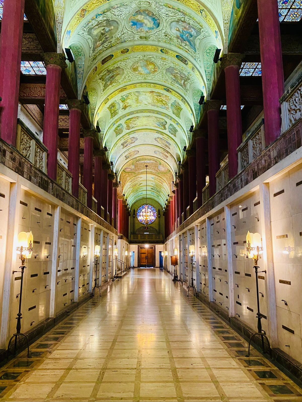 The Great Gallery inside neighboring Mountain View Mausoleum, with painted vaulted ceilings, marble corridors and a stained-glass rose window